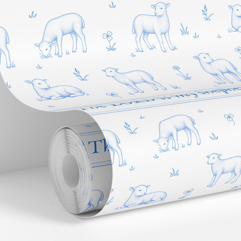 Blue on White colorway: Lamb Toile wallpaper roll standing against a wall