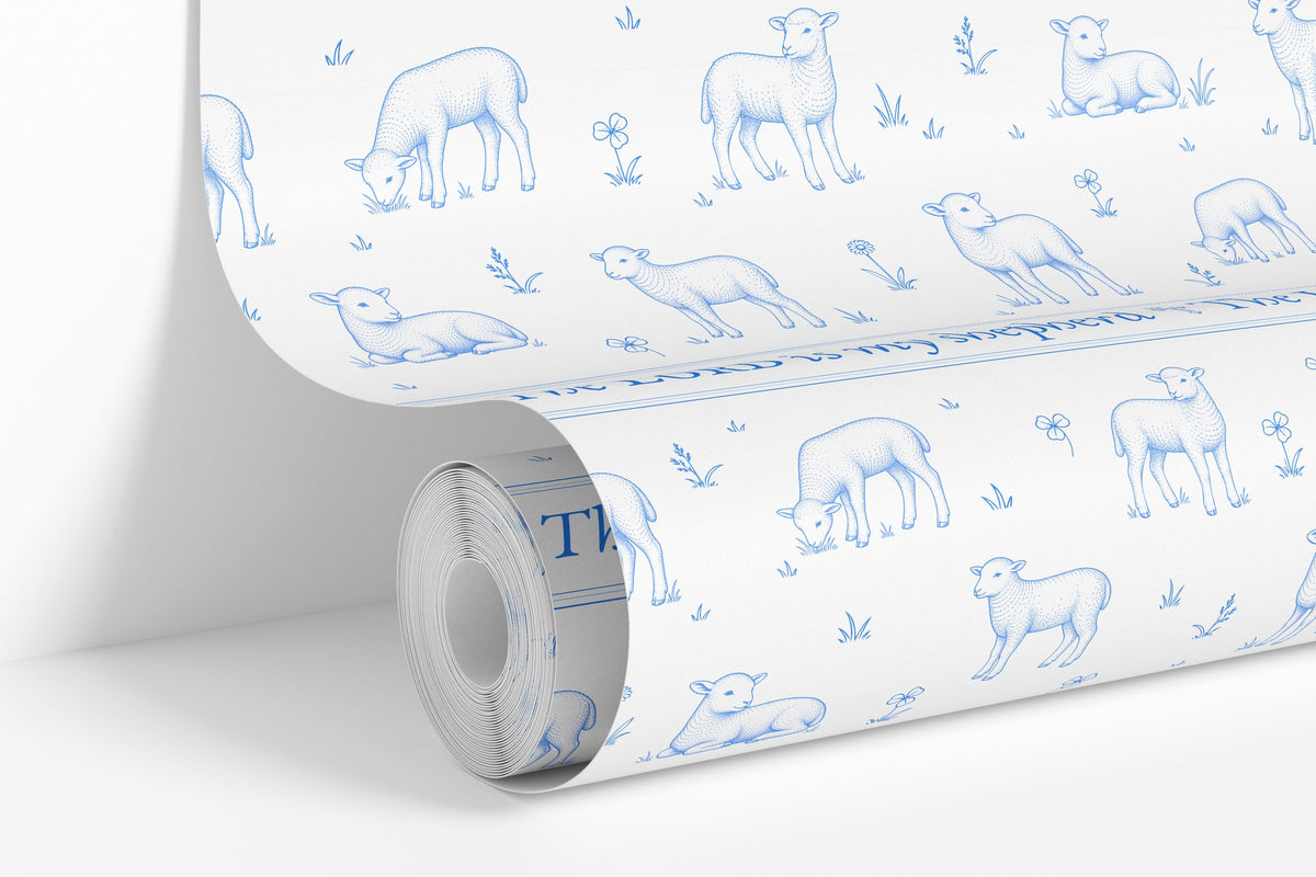 Blue on White colorway: Lamb Toile wallpaper roll standing against a wall