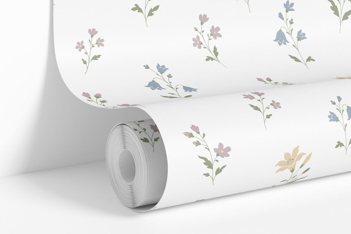 White colorway: Lilies of the Field wallpaper roll standing against a wall